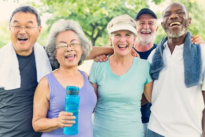 A group of happy residents outdoors smiling and laughing