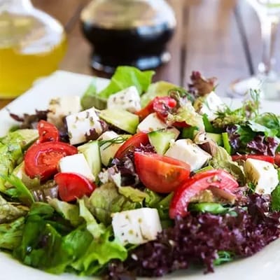A vibrant salad with vegetables and cheese