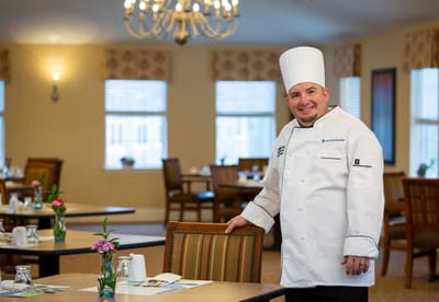 Chef in a well-decorated dining area
