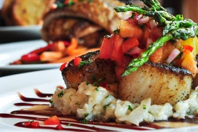A gourmet meal plate with seafood and vegetables