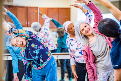 Residents participating in a stretching exercise class
