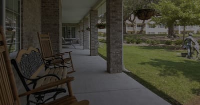 Porch area with rocking chairs and view of garden