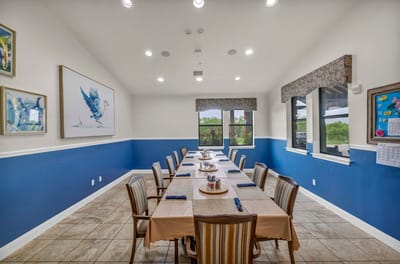 Bright dining room with a long table set for a meal