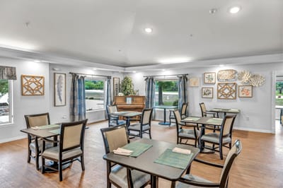 Bright dining room with tables and artwork on the walls