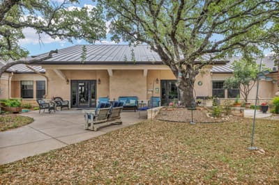 Outdoor seating area with a large tree