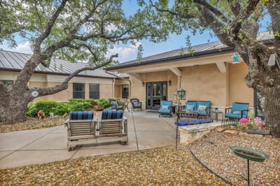 Outdoor seating area with chairs under trees
