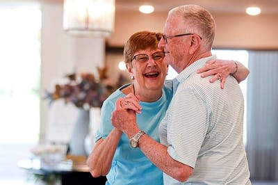 A happy couple dancing in a common area