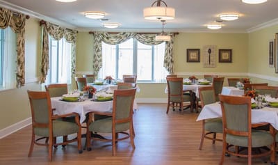 Dining room setup with tables and chairs