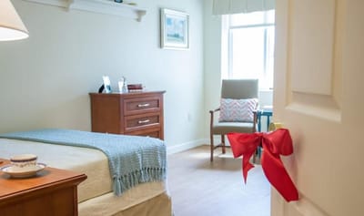 Brightly decorated resident room with cozy furnishings