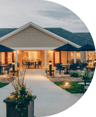 Exterior view of a senior living facility with outdoor seating