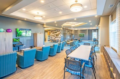 Bright common area with seating and TVs