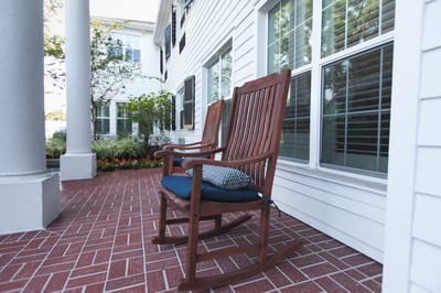 Rocking chairs on a porch at a senior living facility