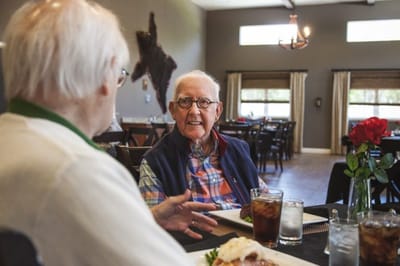 Residents dining together in a cheerful dining room