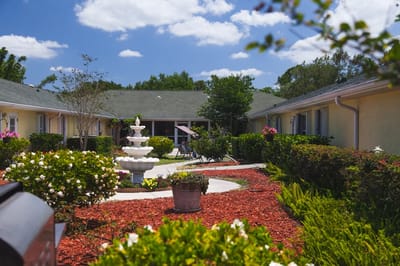 Outdoor courtyard with a fountain and flowers