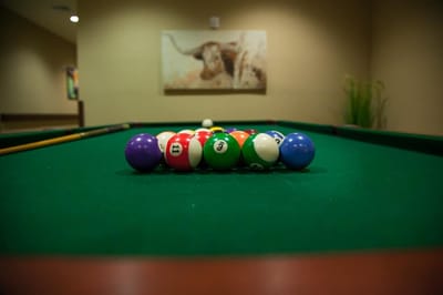 Pool table with colorful balls in a common area