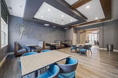 Bright common area with modern seating and wall decor