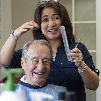 Resident getting a haircut in a salon