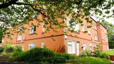 Exterior view of a residential facility surrounded by greenery