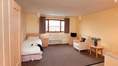 Private resident room with bed and seating area
