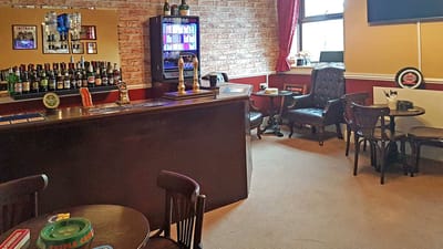 Common area of a bar with seating and drinks