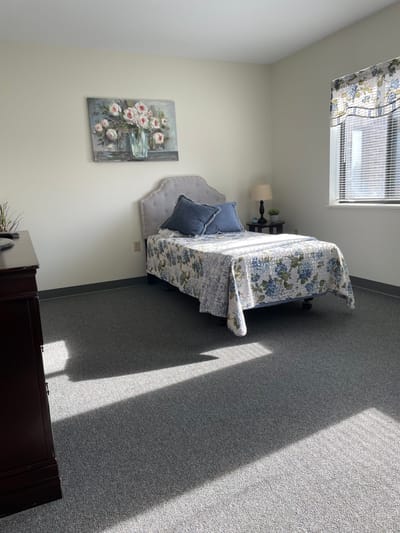 Cozy bedroom in a senior living facility with floral decor