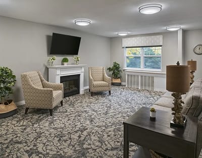 Bright common area with seating and a fireplace