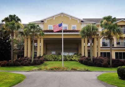 Exterior view of American House Zephyrhills with landscaped entrance