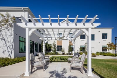 Outdoor seating area with pergola and chairs