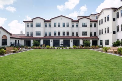 Exterior view of American House Coconut Point with landscaped grounds