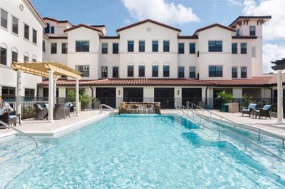 Outdoor pool area with building backdrop