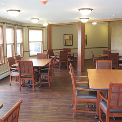 Bright dining area with wooden furniture and ample lighting