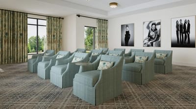 Common area with blue chairs and artwork on walls