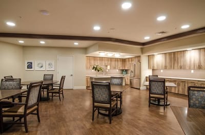 Bright and spacious common area with tables and chairs