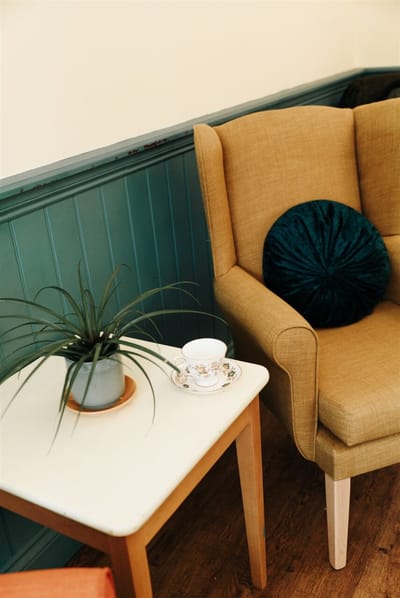 Cozy interior seating area with a plant and tea set