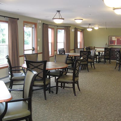Dining area with tables and chairs in a bright common room