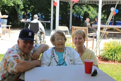 Residents enjoying a gathering outdoors with family