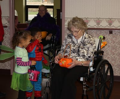 Residents and children in costumes during a Halloween event