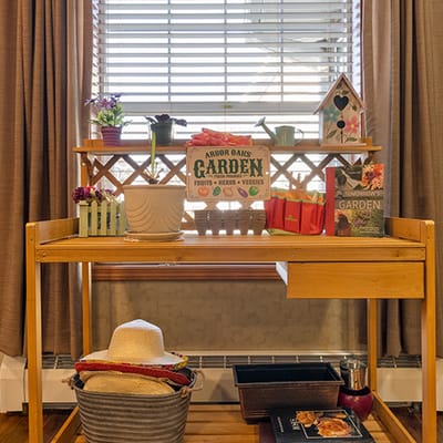 Decorative indoor garden cart with plants and gardening supplies
