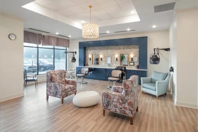 Bright common area with seating and styling stations
