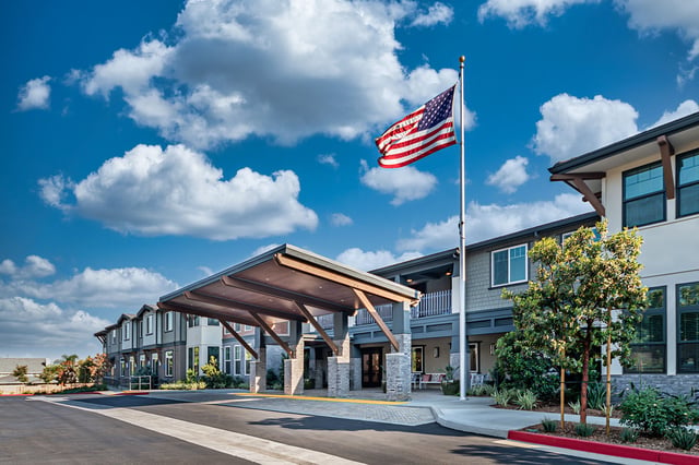 Entrance of Allara Senior Living with American flag
