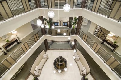 Aerial view of a spacious lobby with seating and hanging lights