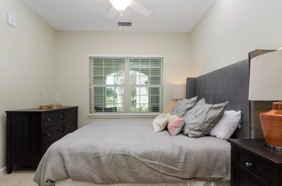 A well-furnished resident bedroom in a senior living facility