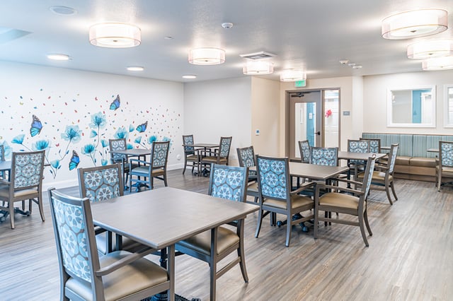 Common area with tables and decorative wall art