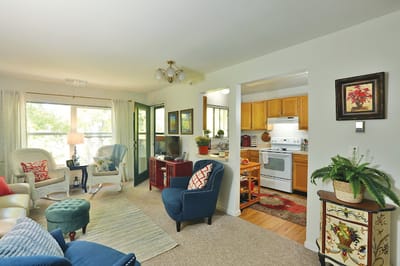 Cozy living room with kitchen view in a senior residence