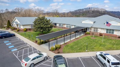 Aerial view of the facility with outdoor space and parking