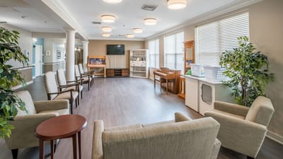 Bright common area with seating and piano