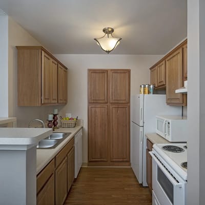Modern kitchen area with wooden cabinets and appliances