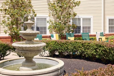 A serene outdoor fountain surrounded by landscaping