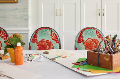 Art supplies on a table in a vibrant activity room