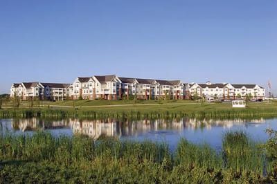 Exterior view of American House Cedarlake by a lake